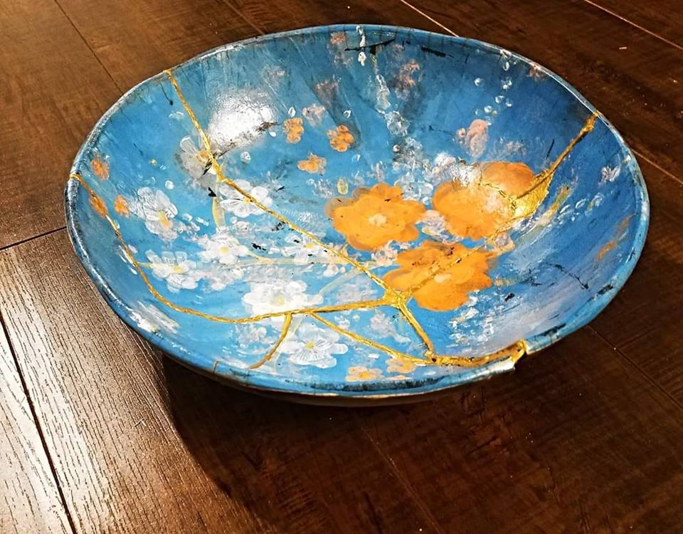 Kintsugi pottery bowl with gold repairs