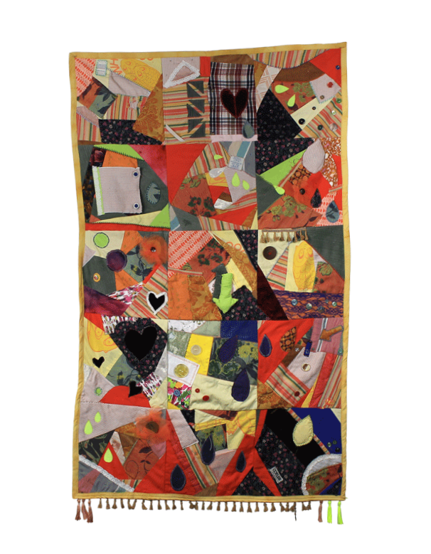 Quilting Amidst Collapse community quilt by Shug Munich and participants, featuring hearts, teardrops, and mixed fabrics.